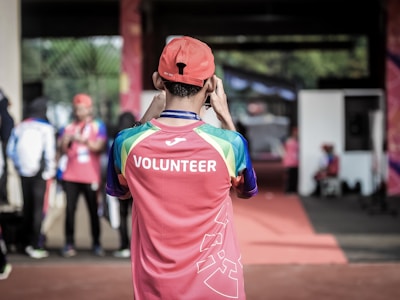 Resources: the back of a person who is wearing a shirt that reads “volunteer”